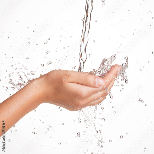  Closeup female hands under the stream of splashing water