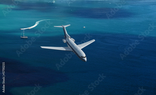 Fototapeta airplane flies over a sea