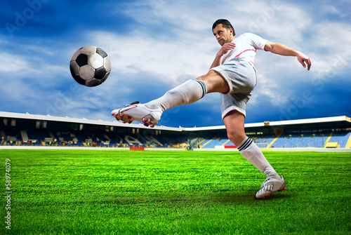 Fototapeta Happiness football player after goal on the field of stadium wit