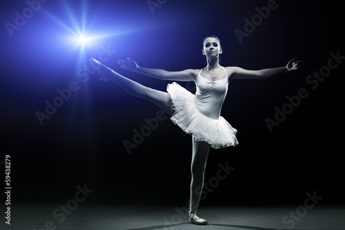  Ballet dancer in white tutu posing on one leg