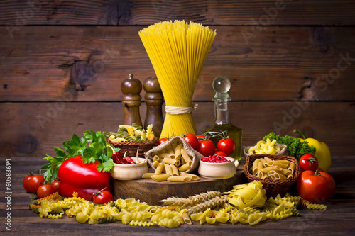 Fototapeta Variety of uncooked pasta and vegetables