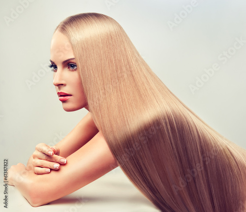  Beautiful blonde woman with long, healthy and shiny hair.