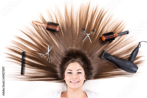 Fototapeta Woman with Beautiful healthy hair and Haircutting Equipment.