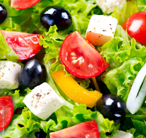 Fototapeta Greek Salad closeup with Feta Cheese, Tomatoes and Olives