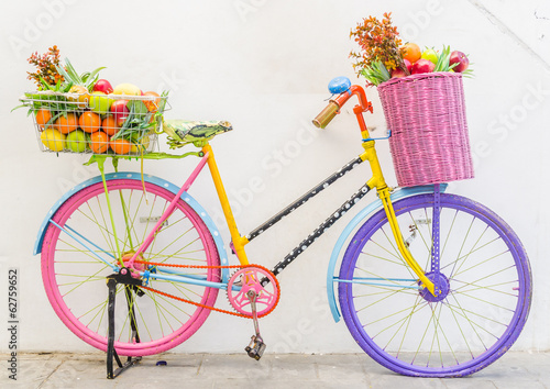Fototapeta Bicycle with basket fruit and flower