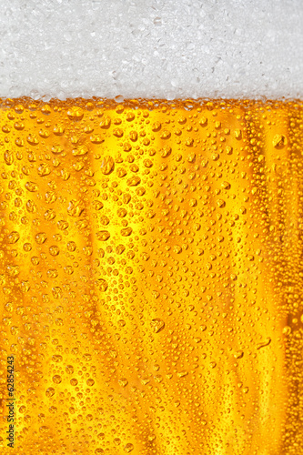 Fototapeta Bubbles and foam in a beer