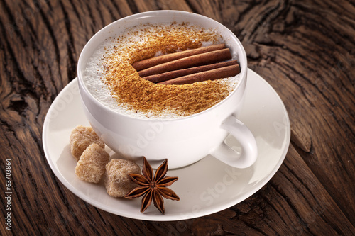 Fototapeta Cup of cappuccino decorated with spices.