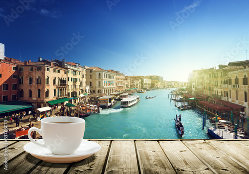 Lacobel coffee on table and Venice in sunset time, Italy