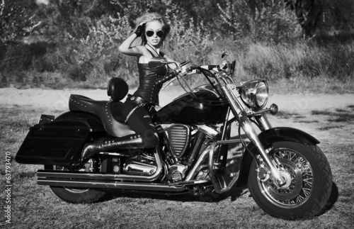  Black and white photo of young beautiful woman on bike