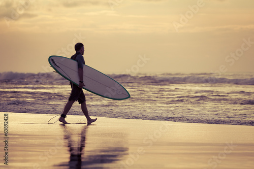 Fototapeta surfer silhouette during sunset