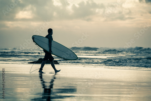 Fototapeta surfer silhouette during sunset