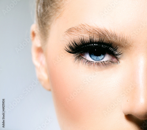 Fototapeta Beauty makeup for blue eyes. Part of beautiful face closeup