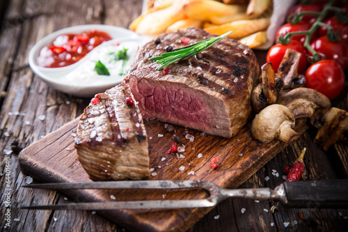 Fototapeta Beef steak on wooden table