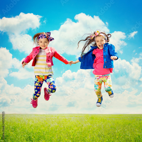  Happy children jumping on the spring field