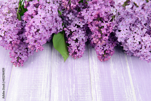 Fototapeta Beautiful lilac flowers on wooden background