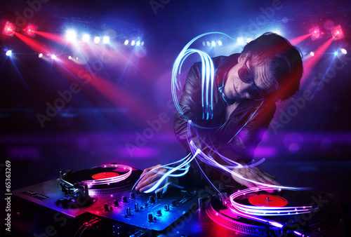  Disc jockey playing music with light beam effects on stage