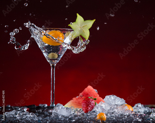 Fototapeta Fresh fruit cocktail in freeze motion splashing