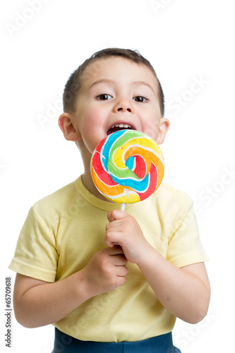 Fototapeta child boy eating lollipop isolated