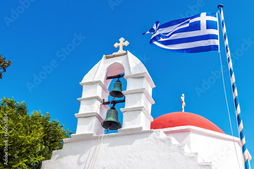 Lacobel Greek flag flying beside the bell tower of a chapel in Mykonos