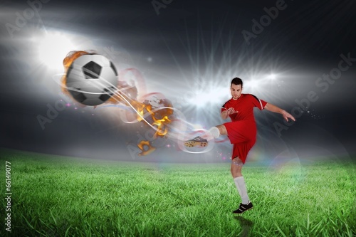 Fototapeta Composite image of football player in red kicking