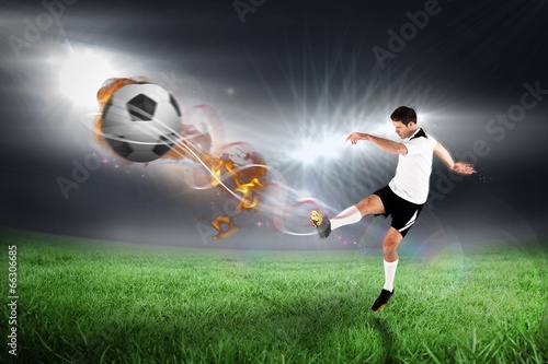  Composite image of football player in white kicking