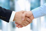 Close-up image of a firm handshake  between two colleagues poster