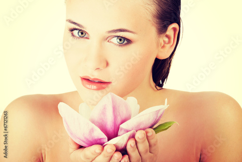  Woman with healthy clean skin and pink flowers