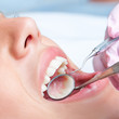 Detail of human teeth with dental equipment.