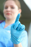 woman doctor in <b>medical gloves</b> - 160_F_69316447_Wvjy0ulfmz3lZQrb0Xr7Wkvw4vWyA5eX