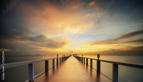 Wooded bridge in the port between sunrise.