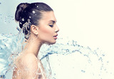 Beautiful model woman with splashes of water in her hands poster