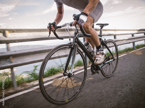 Detail of a road bike with a cyclist pedaling