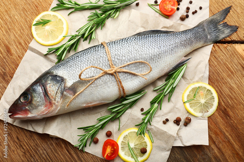 Fresh raw fish and food ingredients on table