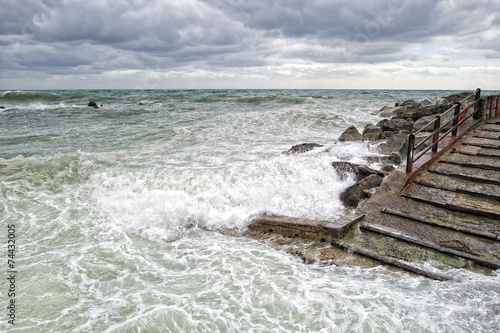 sea in tempest on rocks of italian village