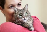 Young woman holding European <b>shorthair cat</b> - 160_F_74515634_bm76yPJ2dEkkLGqgI8Dj1JH2MRKVdQm4