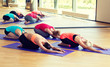 group of women stretching in gym