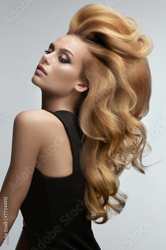 Zdjęcia Hair volume. Portrait of beautiful Blonde with Long Wavy Hair.
