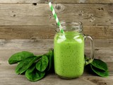 Healthy green smoothie with spinach in a jar mug on wood poster