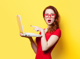 Surprised redhead girl with laptop poster