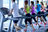 Group of people running on treadmills