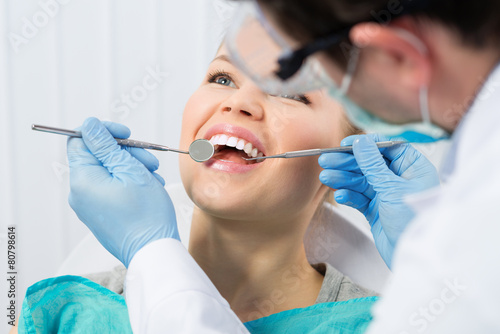 Zdjęcia Regular dentist visit. Caries cure. Young woman visiting dentist