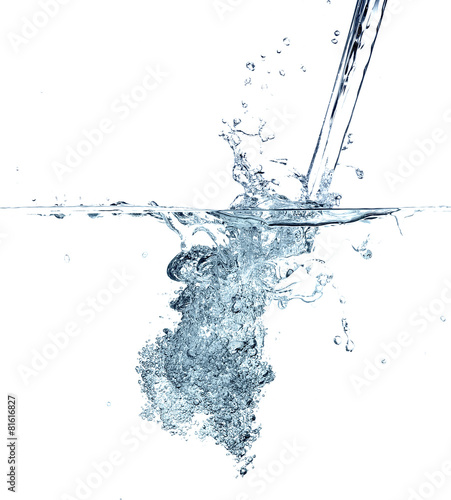 Water making bubbles upon being poured into more water. © master1305