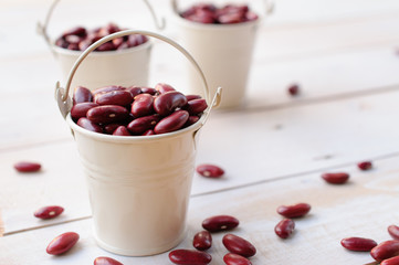 kidney beans in white bucket on wooden board, healthy food