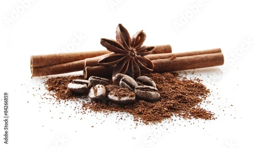 Fototapeta Collected coffee beans with coffee powder on white