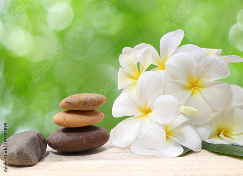 Lacobel Zen spa concept background - Zen massage stones with frangipani plumeria flower