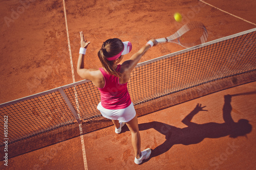 Obraz na plátně Young woman playing tennis.High angle view.Forehand volley.