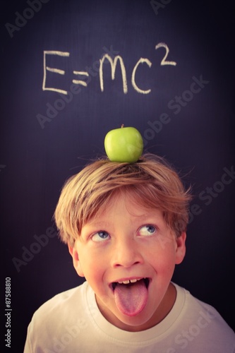 Poster Child with his tongue sticking out balancing an apple on his head next to a form