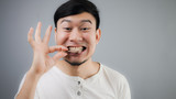 Asian man with chicken bone.