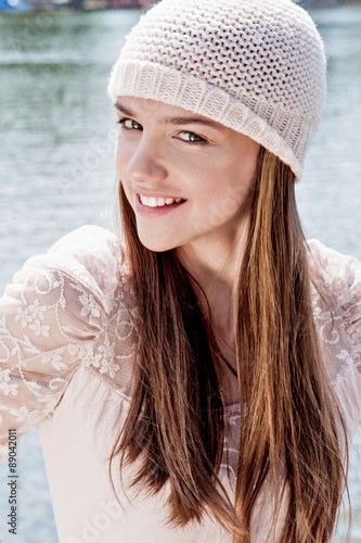 Beautiful girl in hat poses outdoors <b>near water</b> - 500_F_89042011_lzinhbxnCx9krRn58IervyTtF4ulhhGI