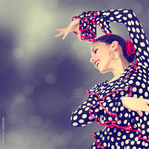 Poster Close-up portrait of a young woman dancing flamenco on abstract background